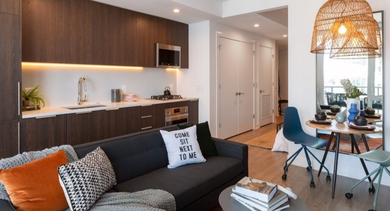 Cozy apartment living room and kitchen combo with modern furnishings and vibrant accents at OLD TOWN PARK TWO Chicago