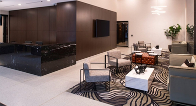 Elegant building lobby with a sleek reception desk, modern lighting, and comfortable seating areas at OLD TOWN PARK TWO Chicago