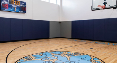 Indoor basketball court with a unique floral design on the court, ideal for active residents at OLD TOWN PARK TWO Chicago