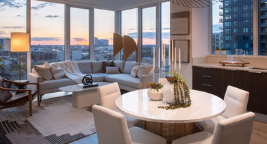Elegant living and dining space with floor-to-ceiling windows offering stunning city light views at OLD TOWN PARK TWO Chicago
