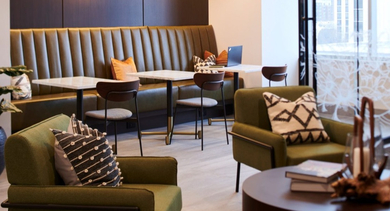Modern lounge and dining area with stylish seating, unique lighting, and large windows at OLD TOWN PARK TWO Chicago