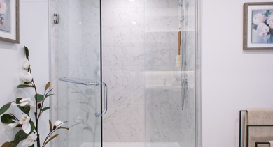 Modern bathroom featuring a spacious walk-in shower with elegant marble-style tiling and glass door at OLD TOWN PARK TWO Chicago