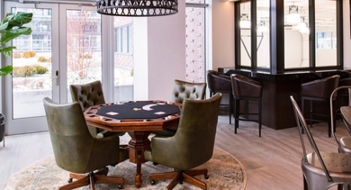 Inviting poker room with a card table and comfortable chairs, with access to an outdoor patio at OLD TOWN PARK TWO Chicago