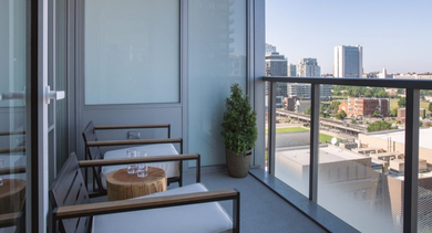 Private balcony with comfortable seating, offering impressive urban views at OLD TOWN PARK TWO Chicago