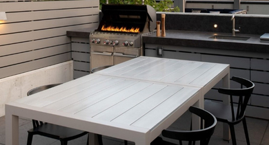 Rooftop grilling station with outdoor dining table, offering city views from a high-rise at OLD TOWN PARK TWO Chicago