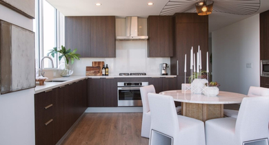 Spacious kitchen and dining area with dark wood cabinets, modern appliances, and elegant dining furniture at OLD TOWN PARK TWO Chicago