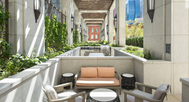 Inviting outdoor lounge and grilling area at One Bennett Park Apartments in Chicago, featuring comfortable seating and modern barbecue stations