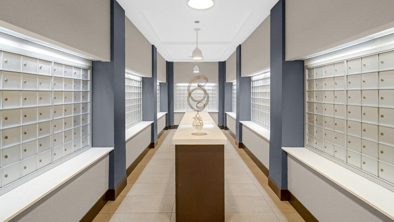 Organized mailroom with lockers and contemporary design at One Superior Place apartments in Chicago