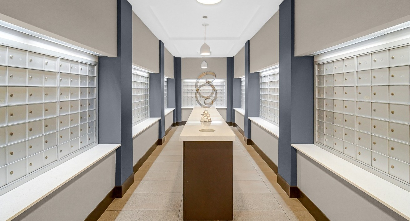 Organized mailroom with lockers and contemporary design at One Superior Place apartments in Chicago