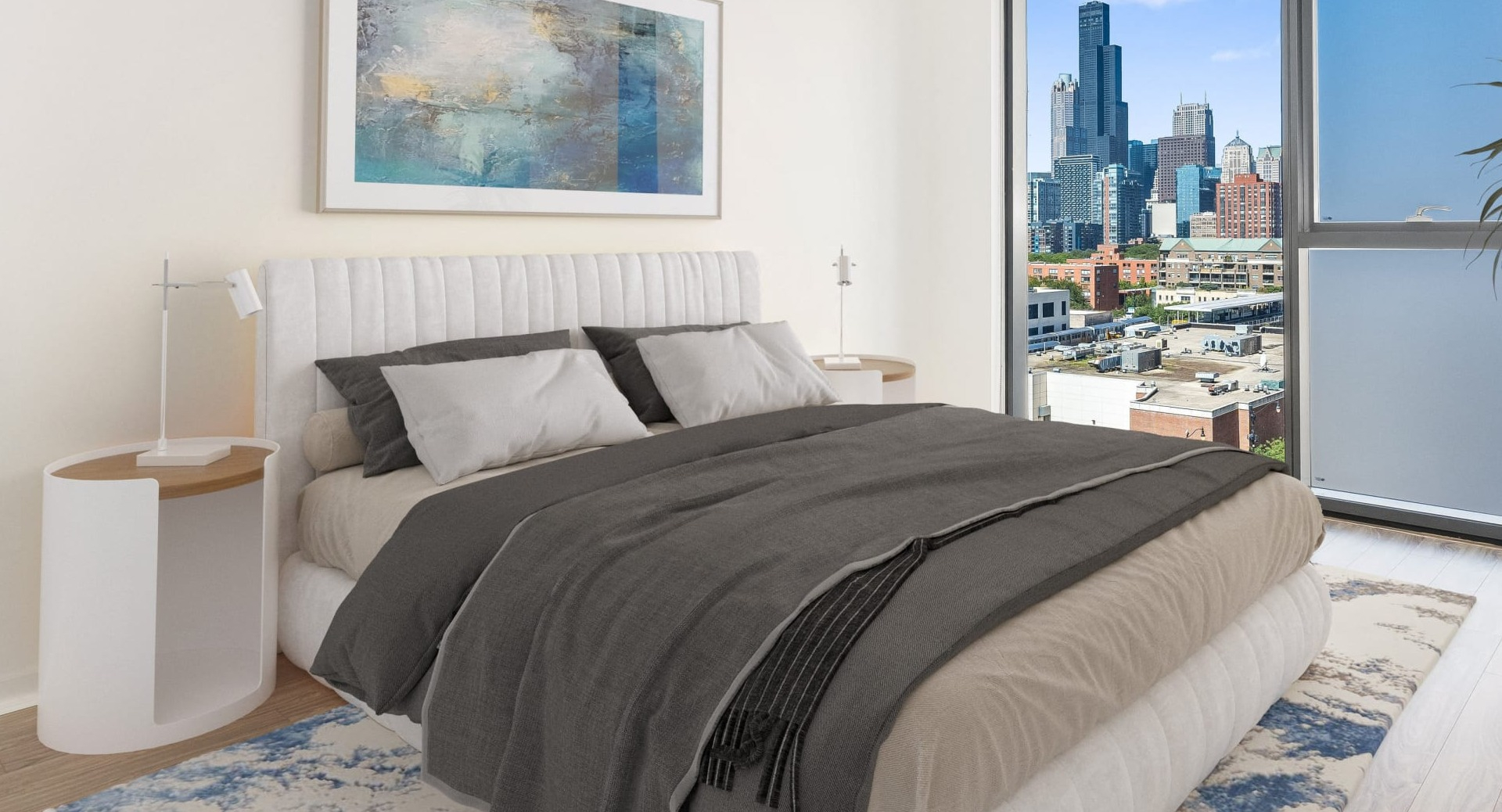 Peaceful bedroom with upholstered bed, large window and partial frosted panel, plus city views at ONE333 apartments in Chicago