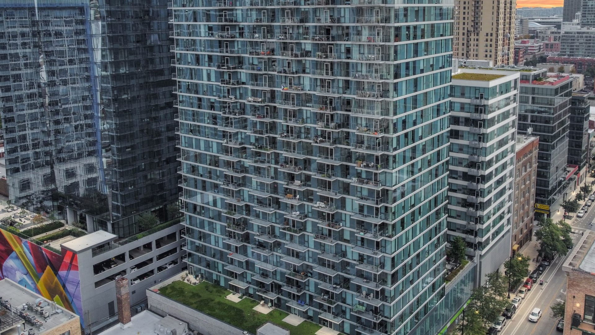 Aerial view of ONE333 apartment tower in Chicago’s South Loop, a modern glass high-rise with private balconies and skyline views close to downtown conveniences
