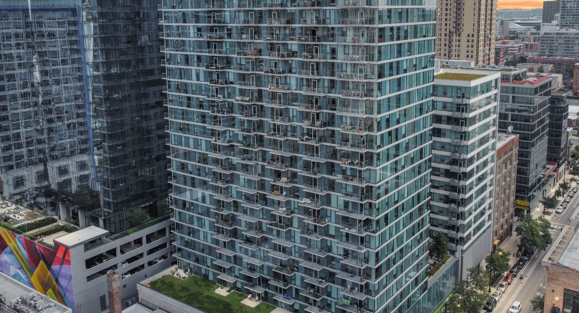 Aerial view of ONE333 apartment tower in Chicago’s South Loop, a modern glass high-rise with private balconies and skyline views close to downtown conveniences