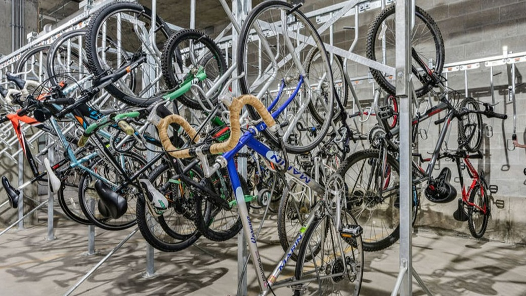 Secure indoor bike storage room at ONE333 apartments in Chicago with vertical racks and ample space for commuters and cycling enthusiasts