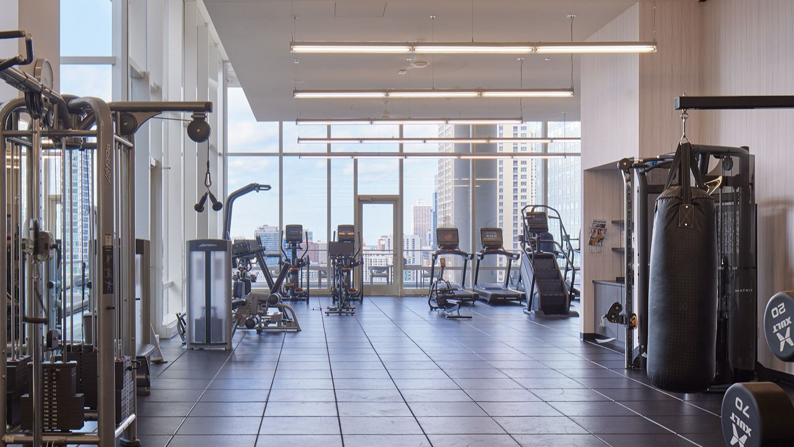 State-of-the-art fitness center at OneEleven in Chicago, equipped with various machines, free weights, and ample workout space