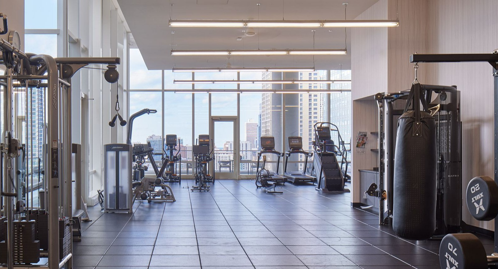 State-of-the-art fitness center at OneEleven in Chicago, equipped with various machines, free weights, and ample workout space