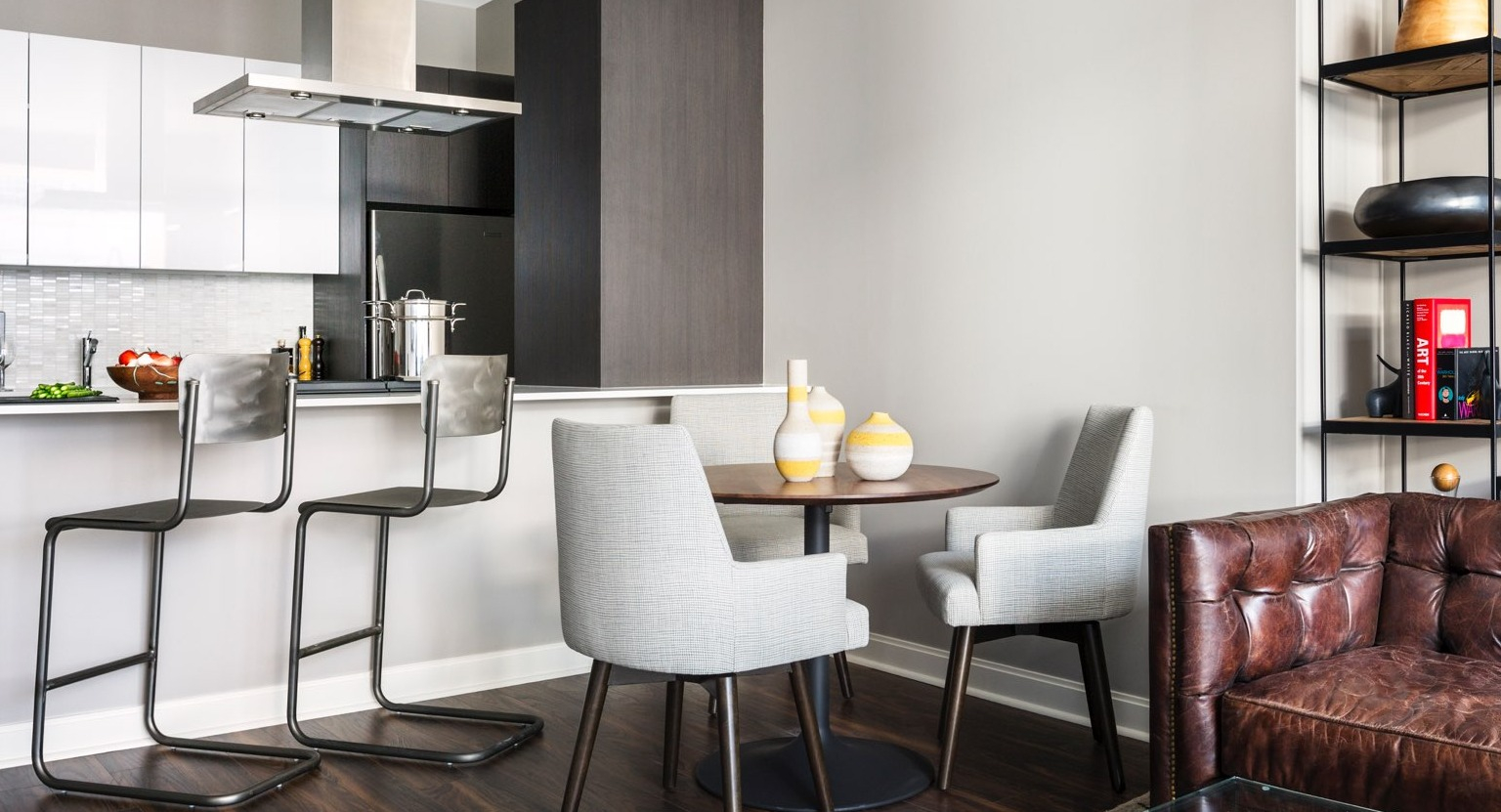 Open-concept apartment at OneEleven in Chicago, featuring a modern kitchen, dining area, and a comfortable living space