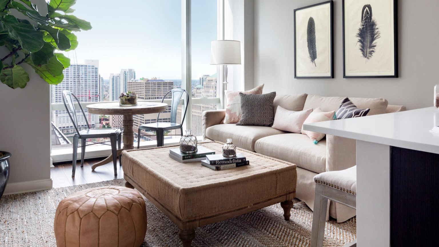 Bright and inviting living room at OneEleven in Chicago, seamlessly connected to a modern kitchen and offering captivating city views