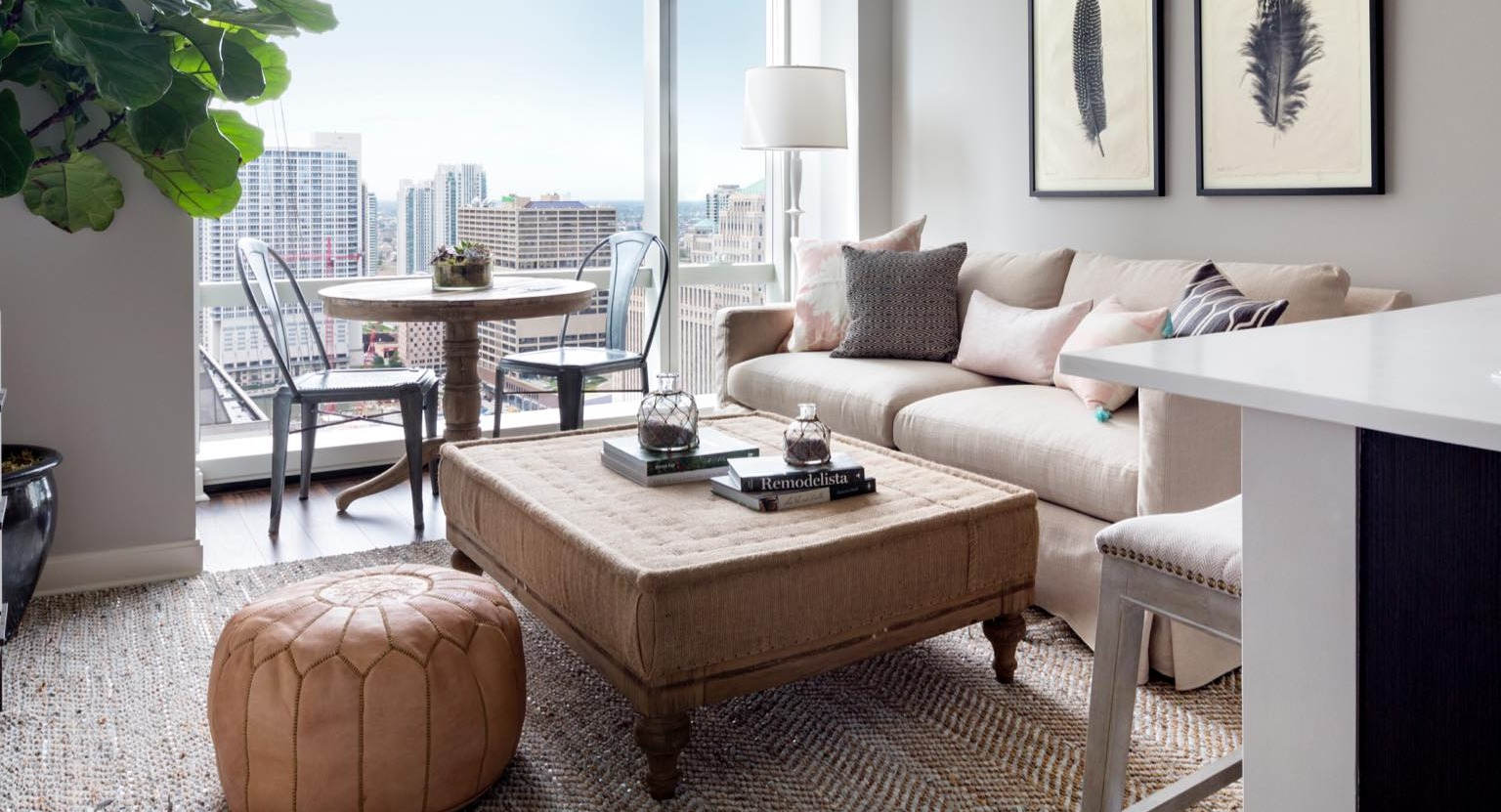Bright and inviting living room at OneEleven in Chicago, seamlessly connected to a modern kitchen and offering captivating city views