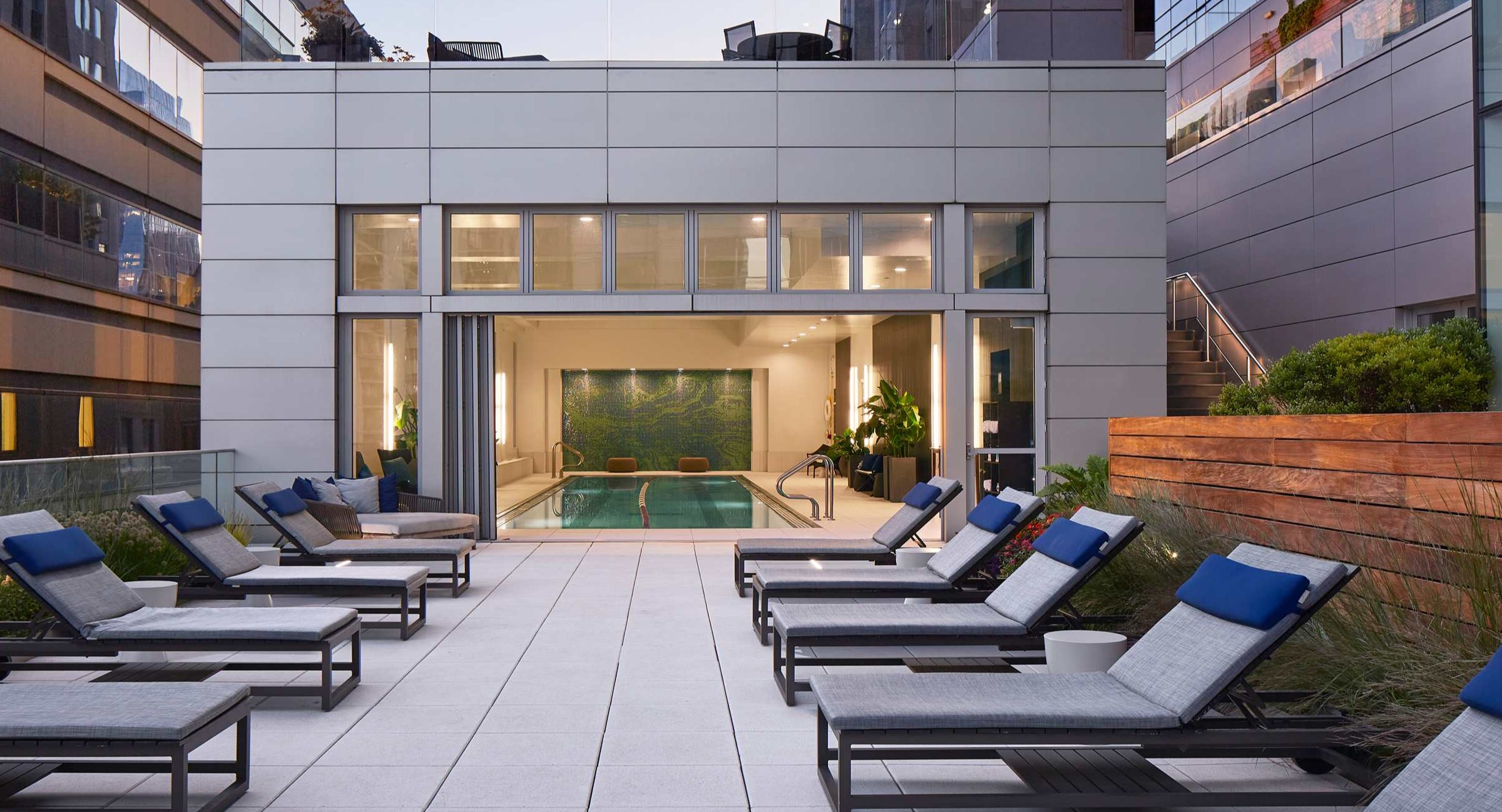 Expansive outdoor deck at OneEleven in Chicago, offering lounge seating and direct access to a beautiful indoor pool