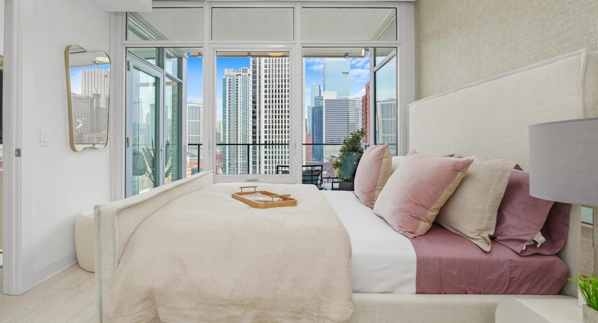 Luxurious bedroom at Onni Fulton Market in Chicago, featuring a large bed, stylish decor, and a private balcony with city views