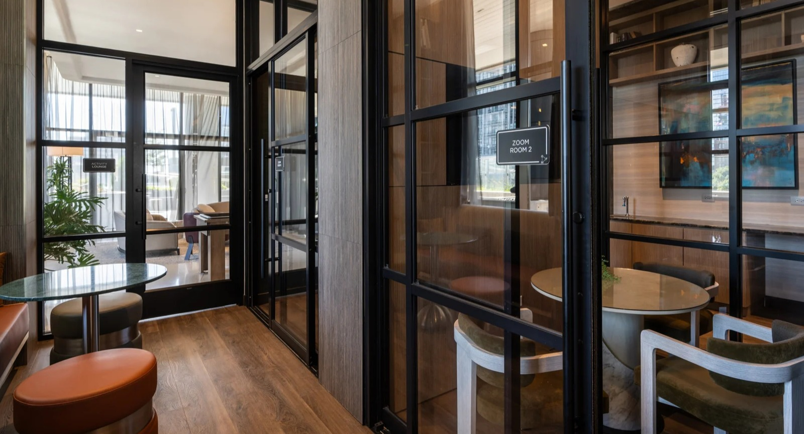 Modern co-working spaces at Onni Fulton Market in Chicago, featuring private "Zoom rooms" and collaborative seating for residents