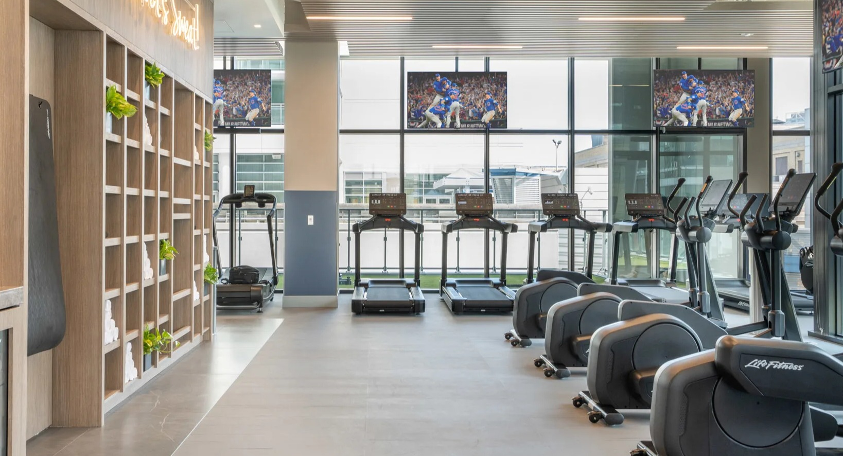 State-of-the-art fitness center at Onni Fulton Market in Chicago, featuring cardio machines, weight equipment, and large screens