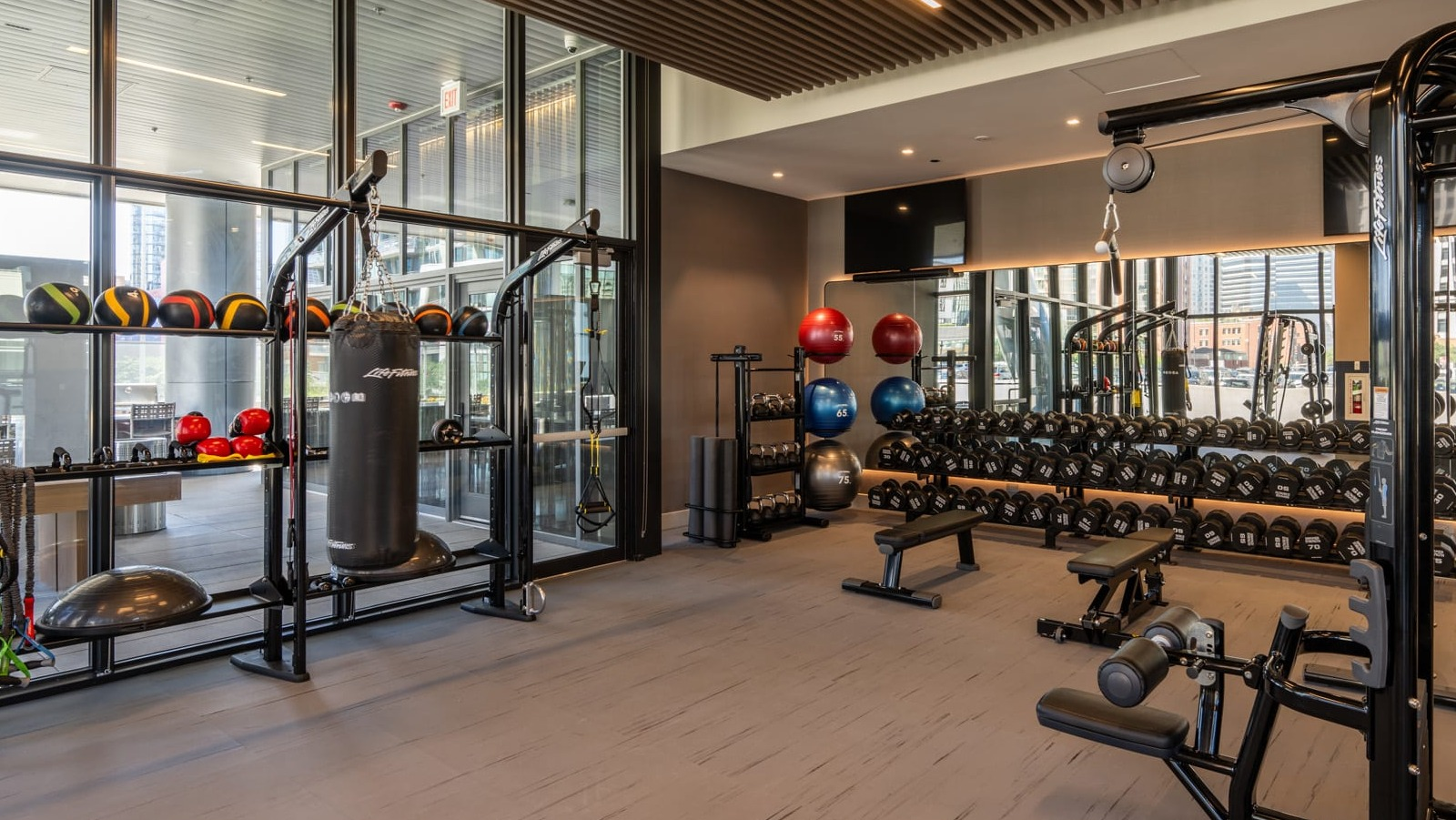 Functional training gym at Onni Fulton Market in Chicago, with a punching bag, medicine balls, and various equipment for dynamic workouts