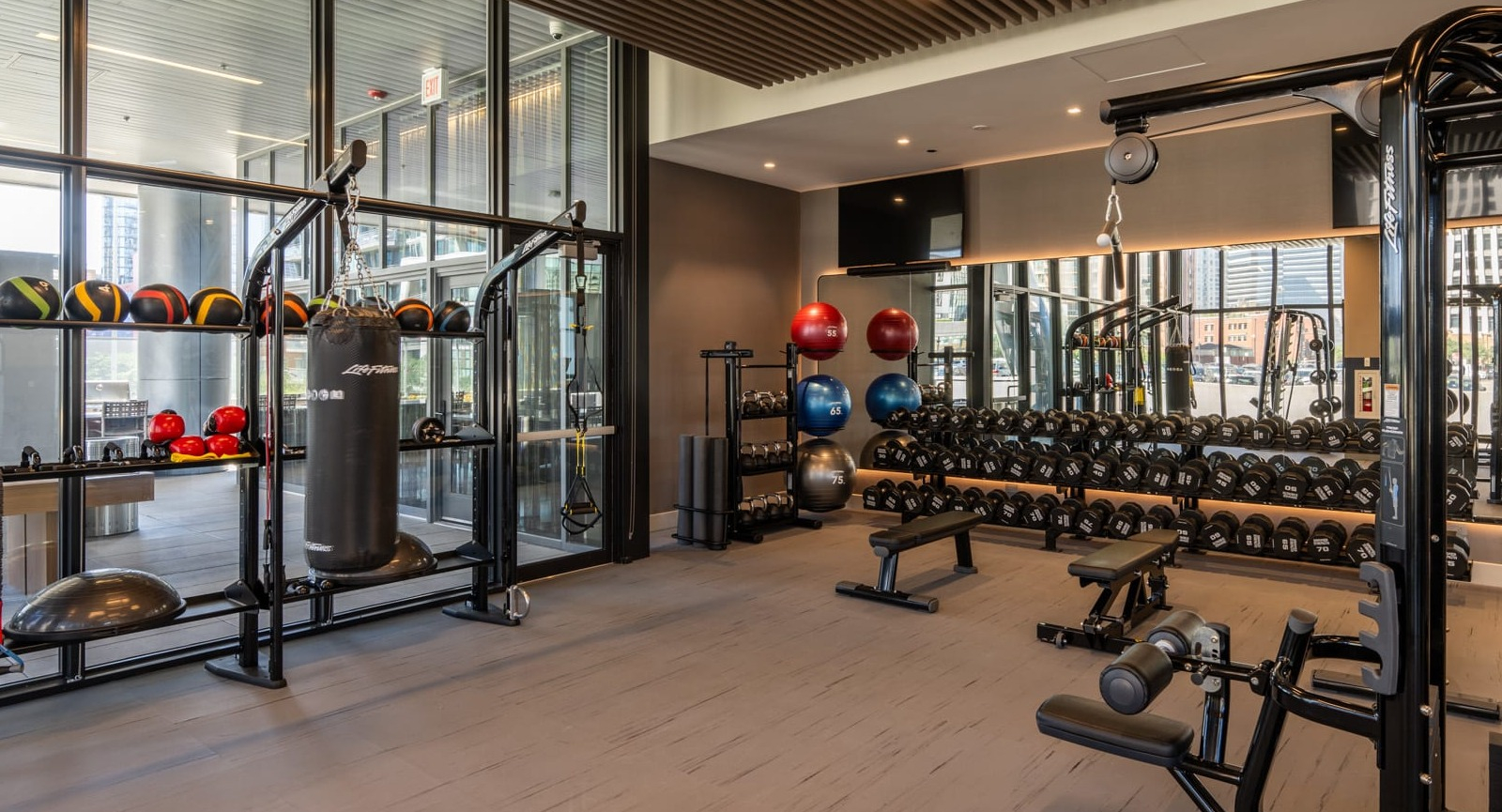 Functional training gym at Onni Fulton Market in Chicago, with a punching bag, medicine balls, and various equipment for dynamic workouts