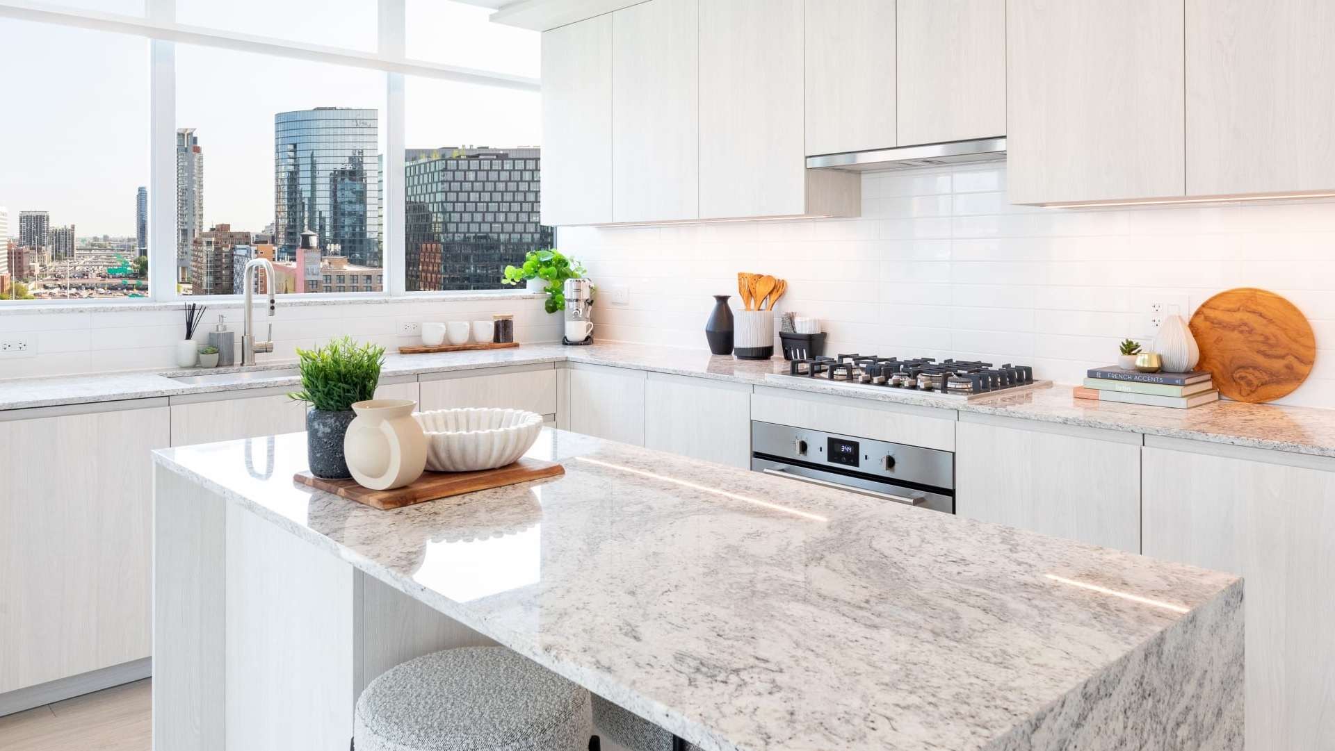 Bright and spacious apartment kitchen at Onni Fulton Market in Chicago, featuring a large island, stainless steel appliances, and ample counter space