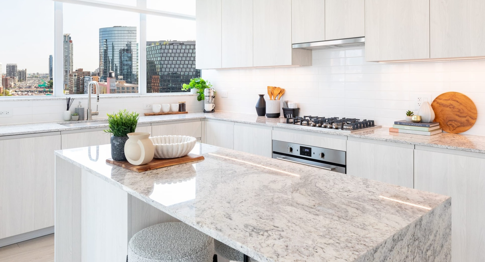 Bright and spacious apartment kitchen at Onni Fulton Market in Chicago, featuring a large island, stainless steel appliances, and ample counter space