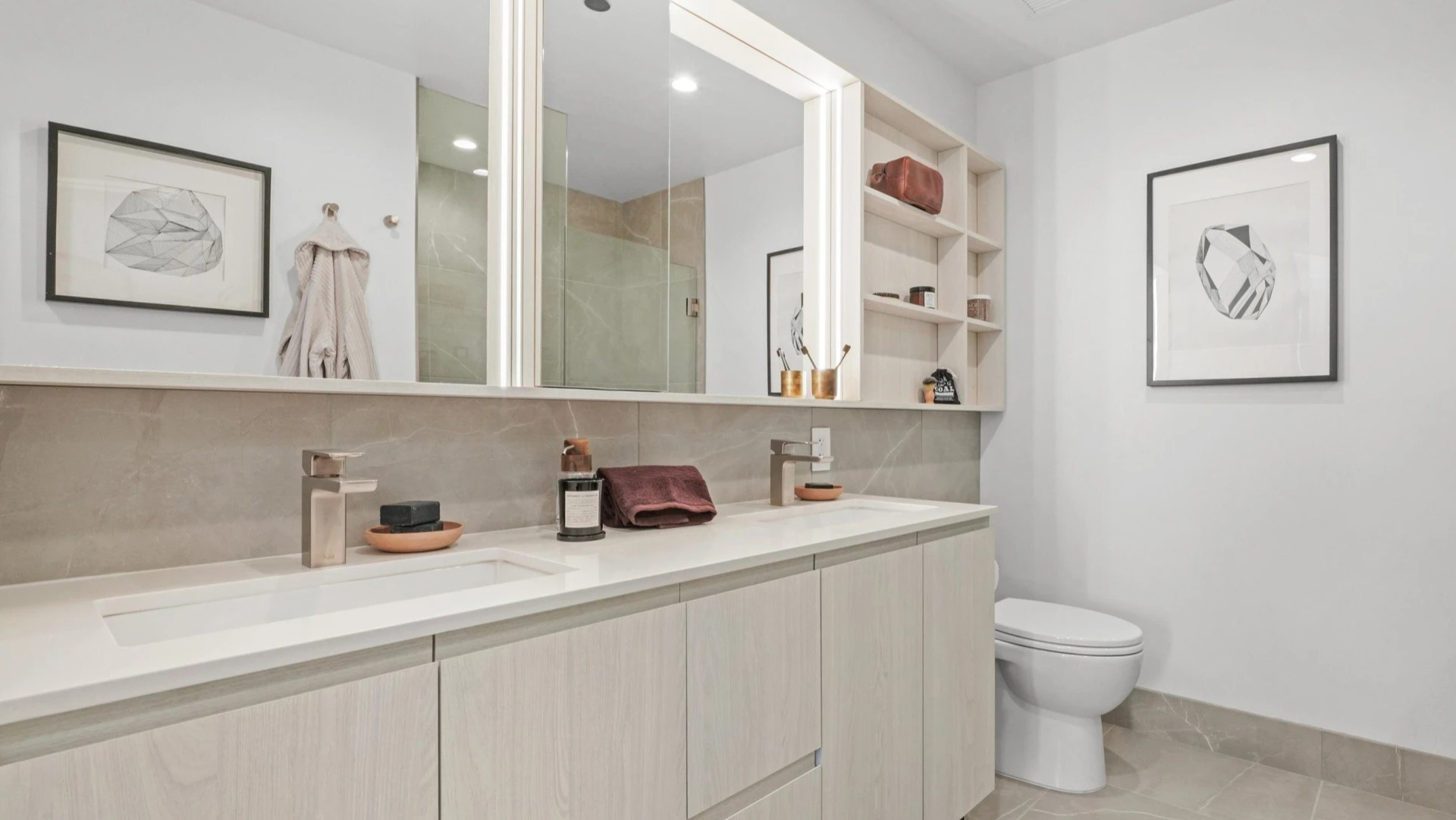 Spacious master bathroom at Onni Fulton Market in Chicago, featuring a double vanity, large mirrors, and sleek modern finishes