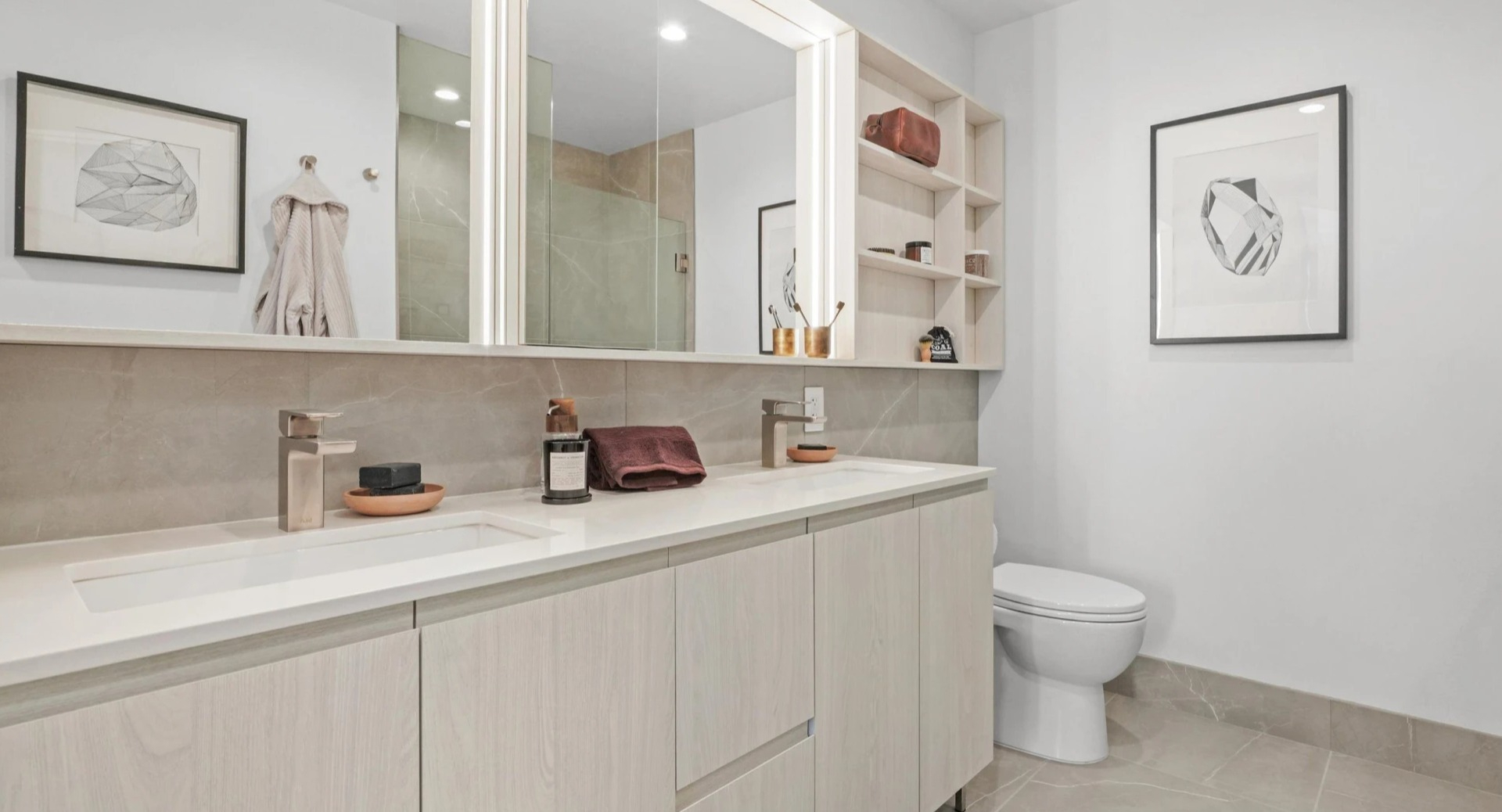Spacious master bathroom at Onni Fulton Market in Chicago, featuring a double vanity, large mirrors, and sleek modern finishes