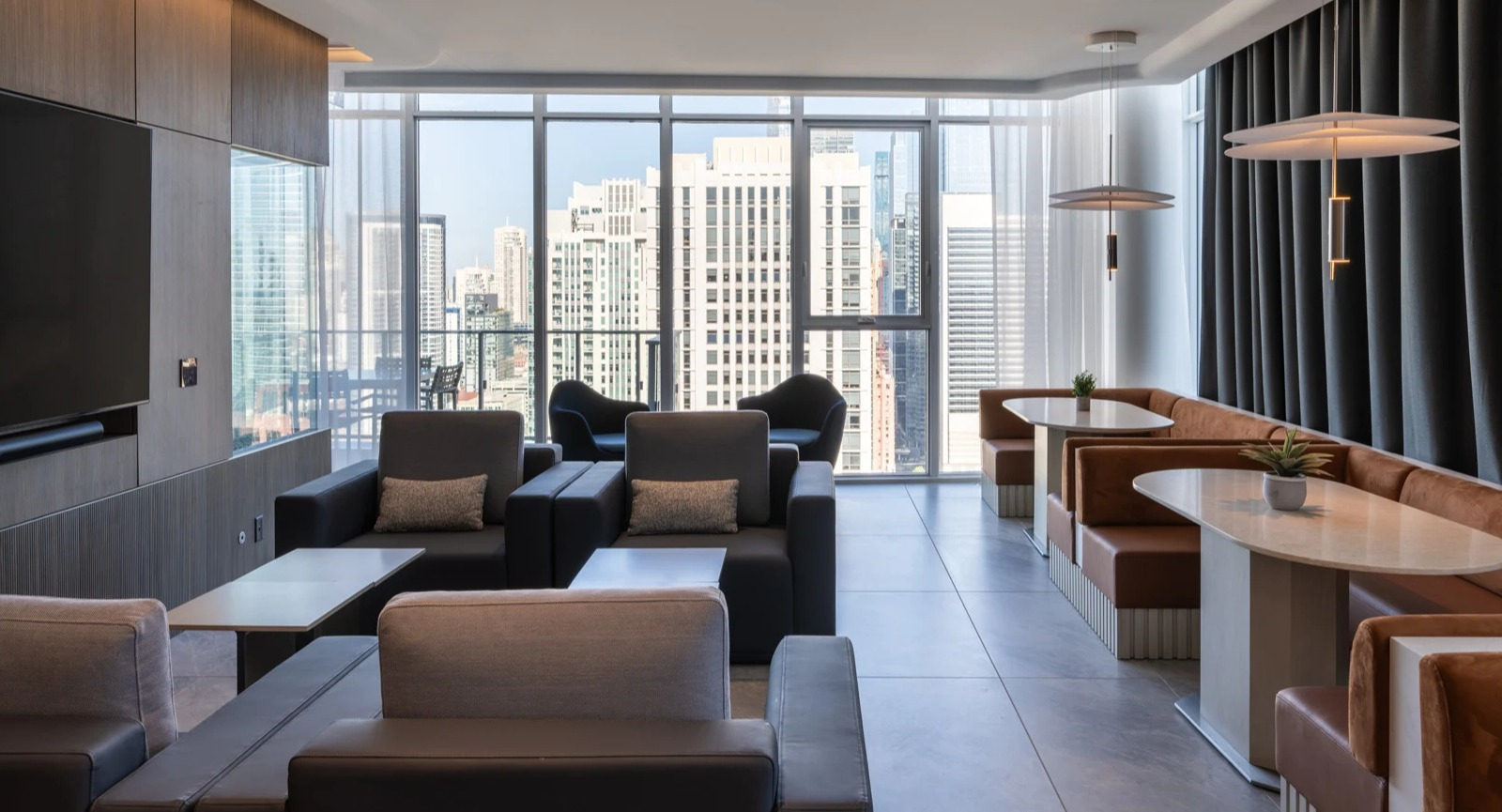 Chic sky lounge at Onni Fulton Market in Chicago, featuring comfortable seating, dining areas, and panoramic city views