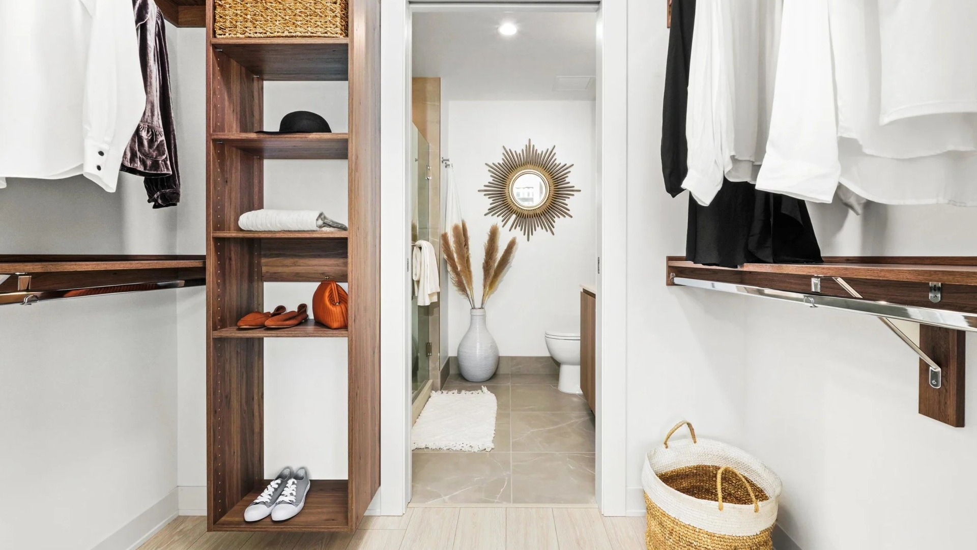 Generous walk-in closet at Onni Fulton Market in Chicago, featuring custom shelving, hanging space, and direct access to a modern bathroom