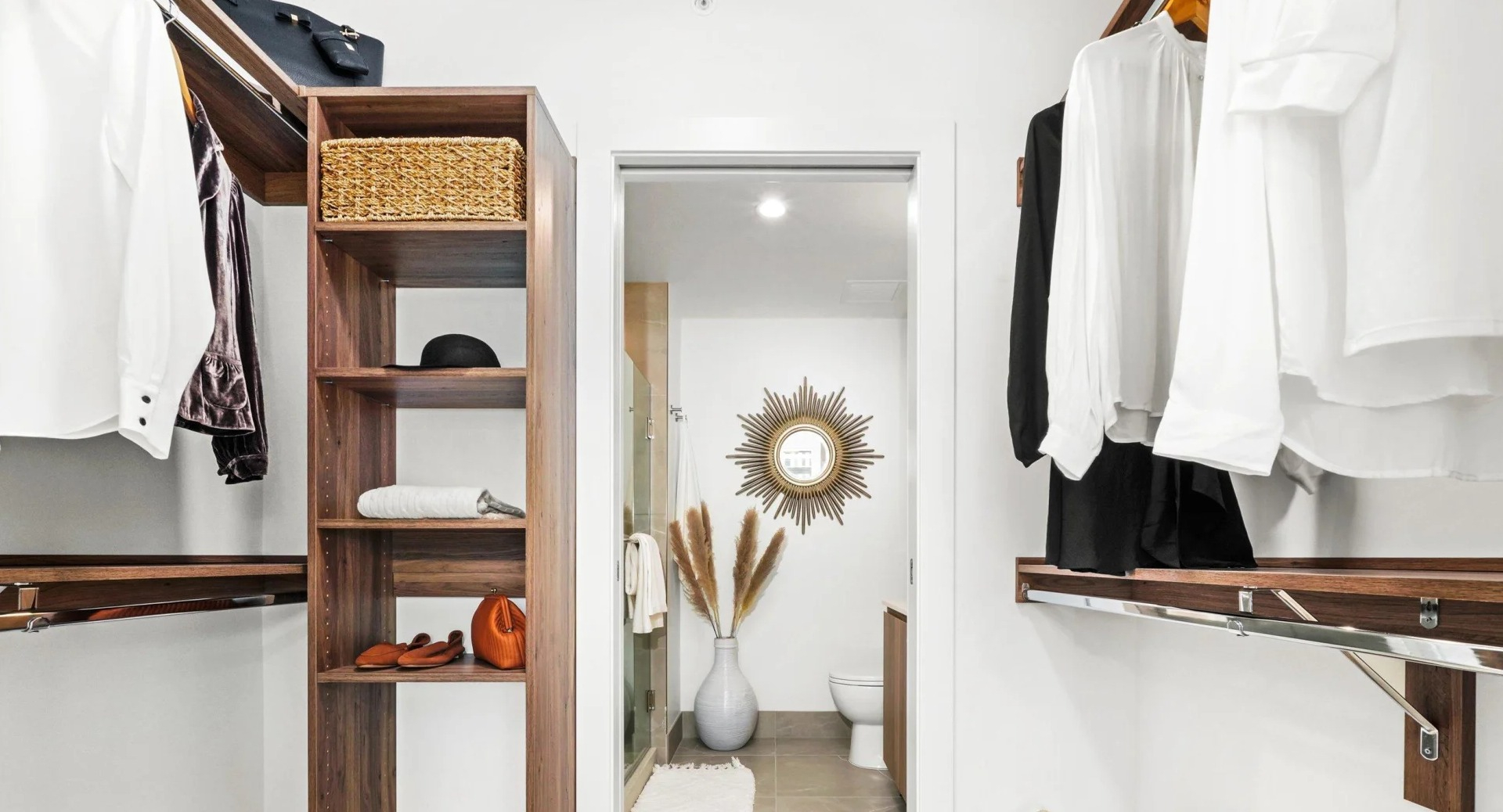 Generous walk-in closet at Onni Fulton Market in Chicago, featuring custom shelving, hanging space, and direct access to a modern bathroom
