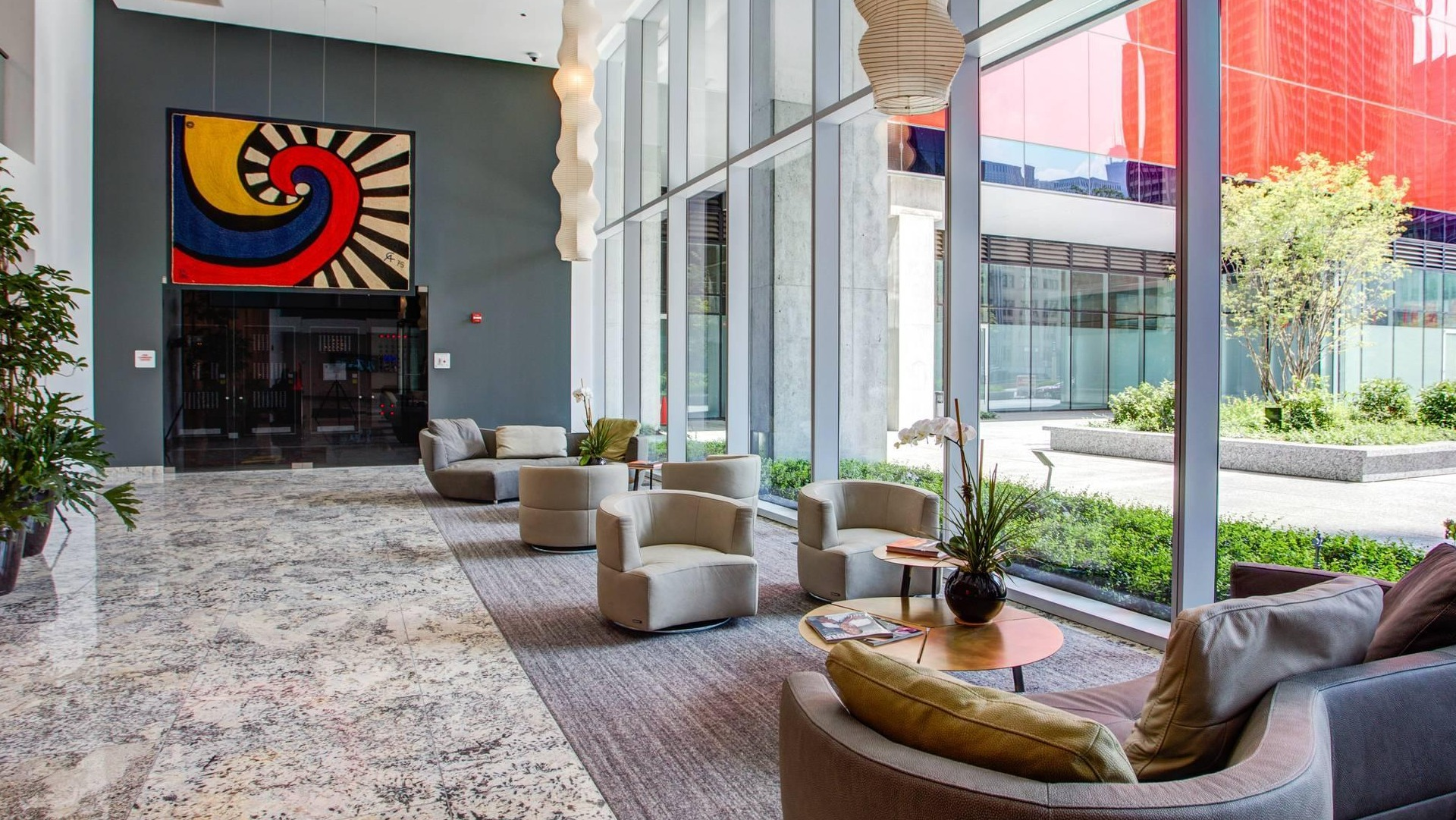 Elegant lobby at Optima Signature featuring modern seating, floor-to-ceiling windows, and stylish artwork in downtown Chicago