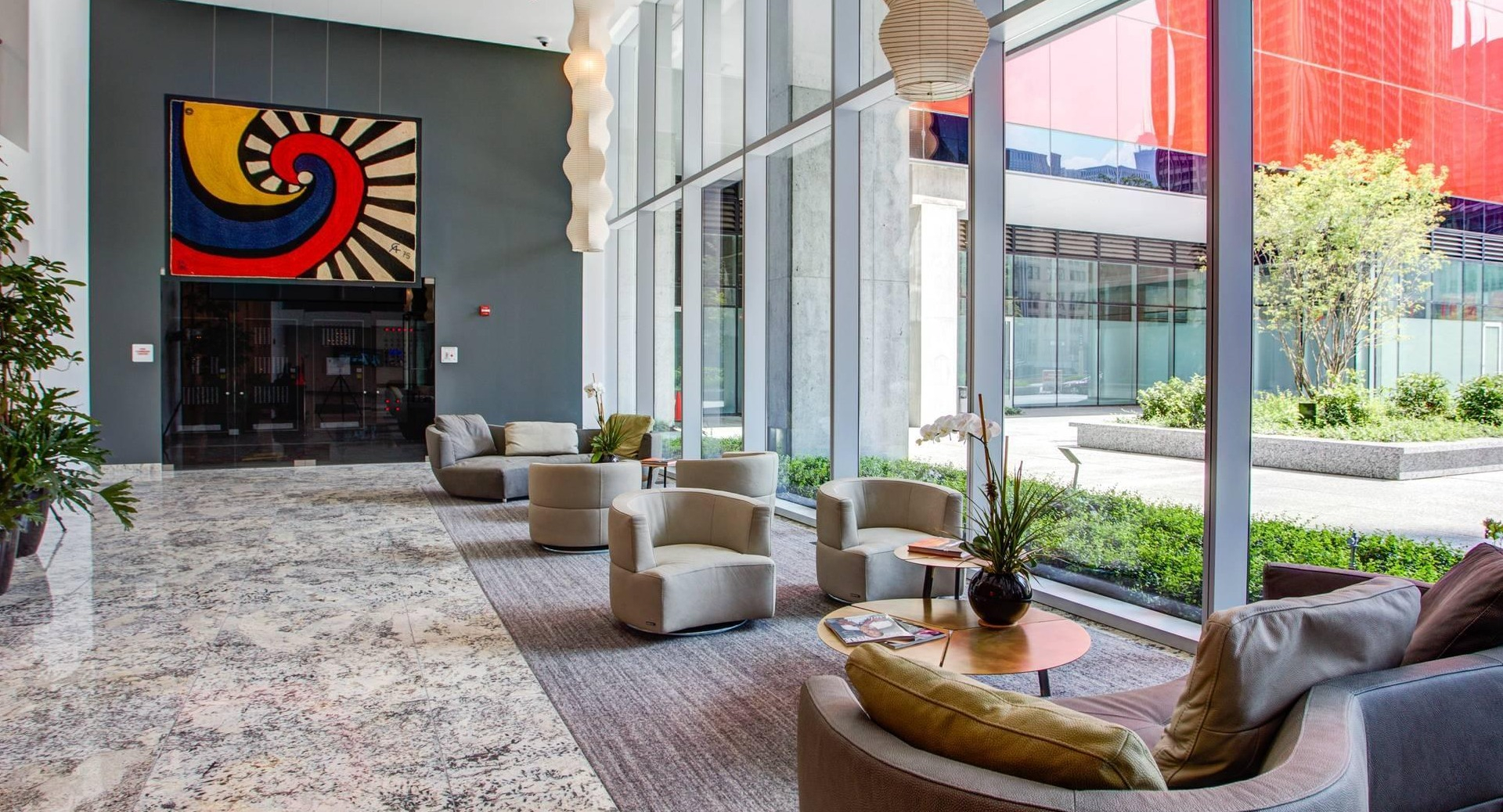 Elegant lobby at Optima Signature featuring modern seating, floor-to-ceiling windows, and stylish artwork in downtown Chicago