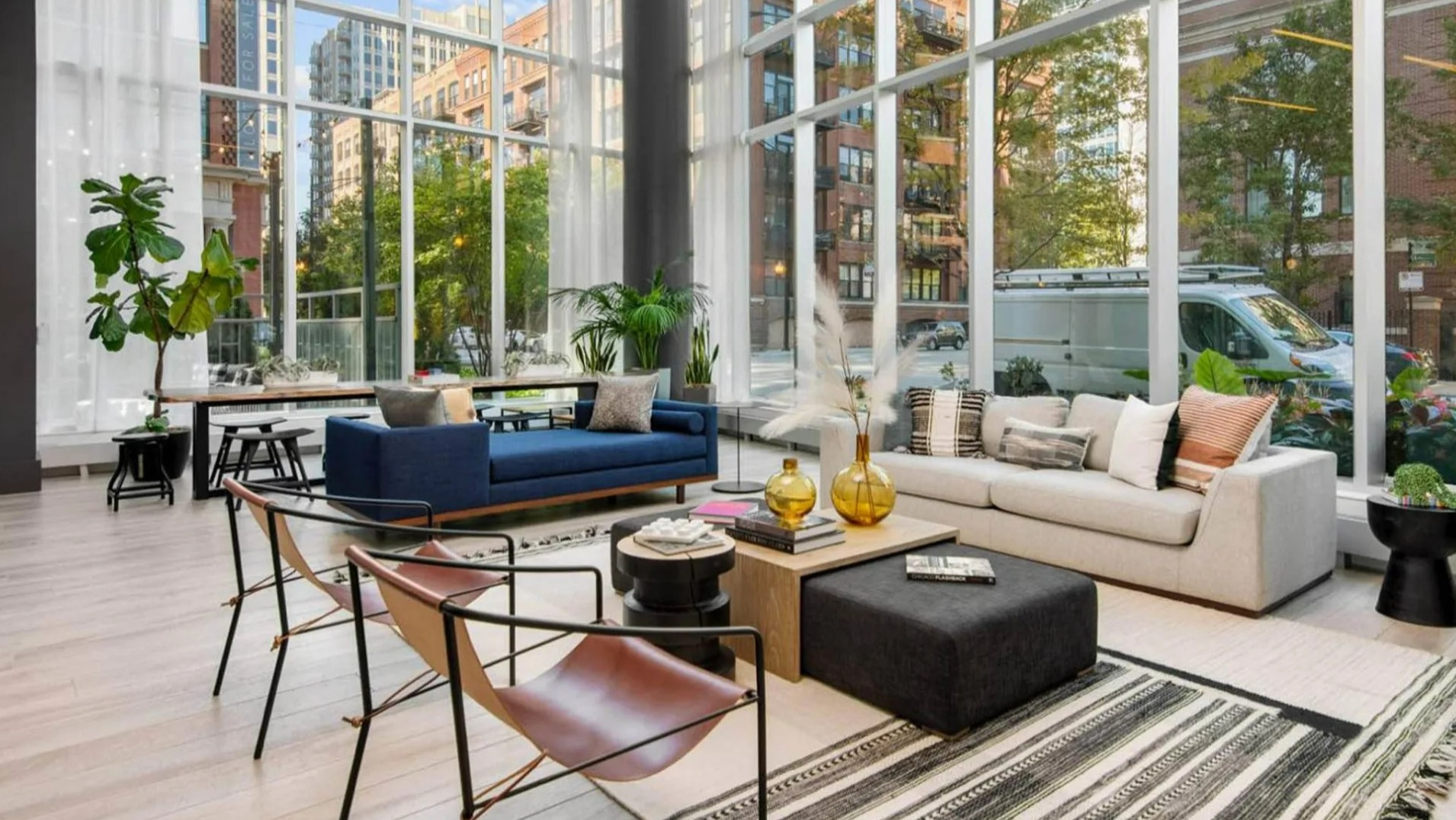 Expansive lobby lounge at Parc Huron in Chicago, featuring floor-to-ceiling windows, modern furniture, and a bright, inviting atmosphere