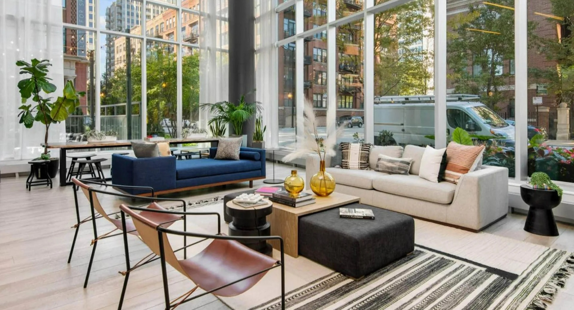 Expansive lobby lounge at Parc Huron in Chicago, featuring floor-to-ceiling windows, modern furniture, and a bright, inviting atmosphere