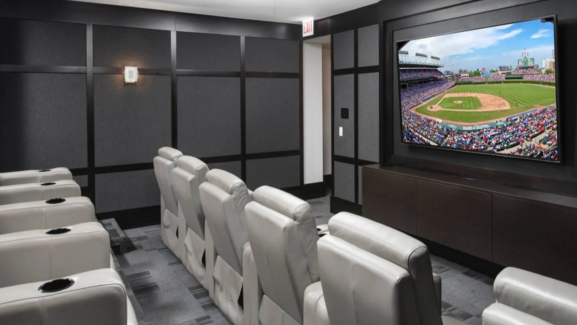 Private media room and theater at Parc Huron in Chicago, featuring comfortable recliners and a large screen for movies or sports