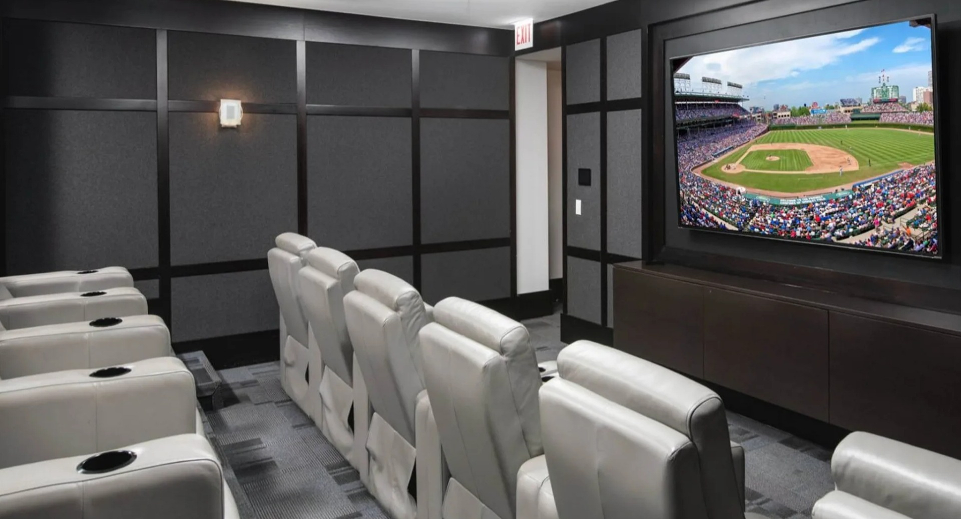 Private media room and theater at Parc Huron in Chicago, featuring comfortable recliners and a large screen for movies or sports