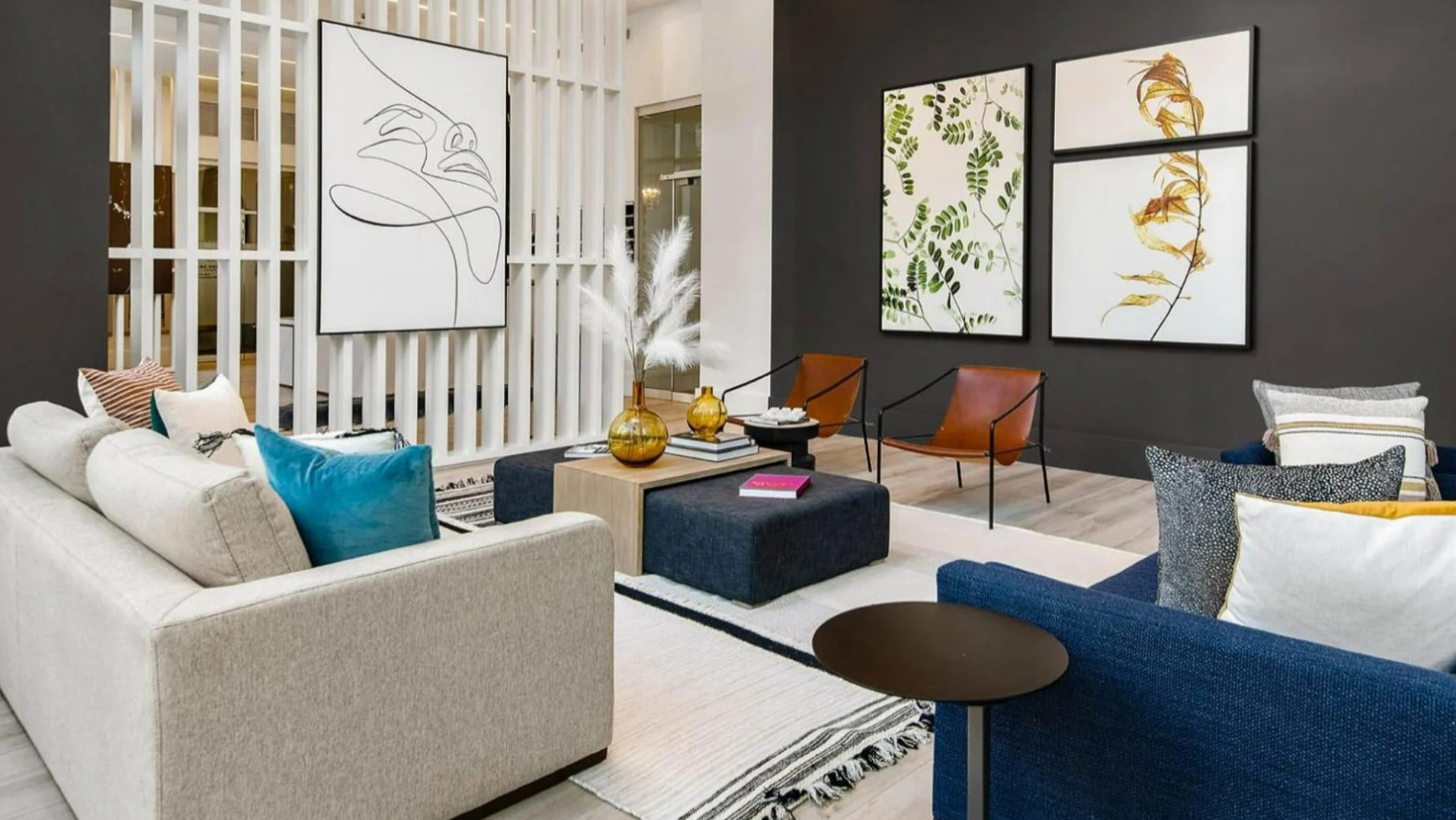 Stylish resident lounge at Parc Huron in Chicago, featuring modern art, comfortable sofas, and elegant room dividers