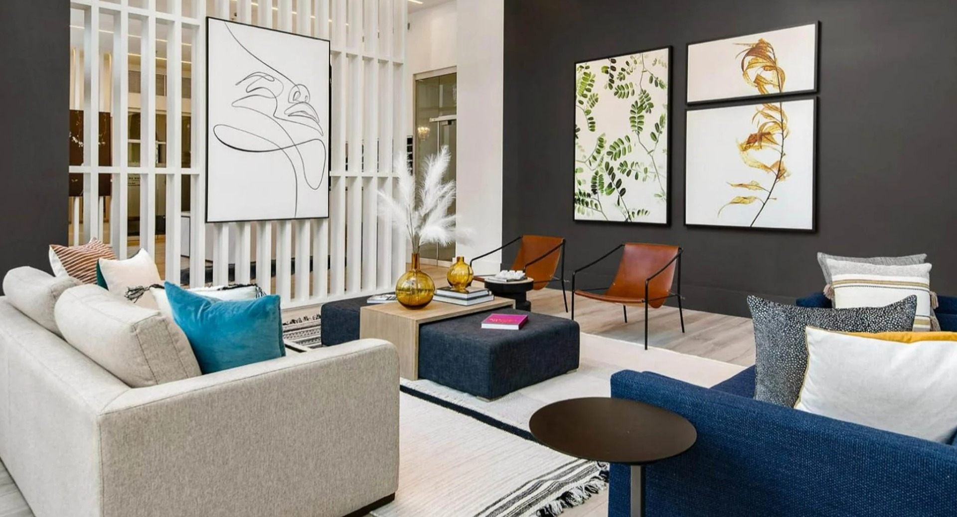 Stylish resident lounge at Parc Huron in Chicago, featuring modern art, comfortable sofas, and elegant room dividers