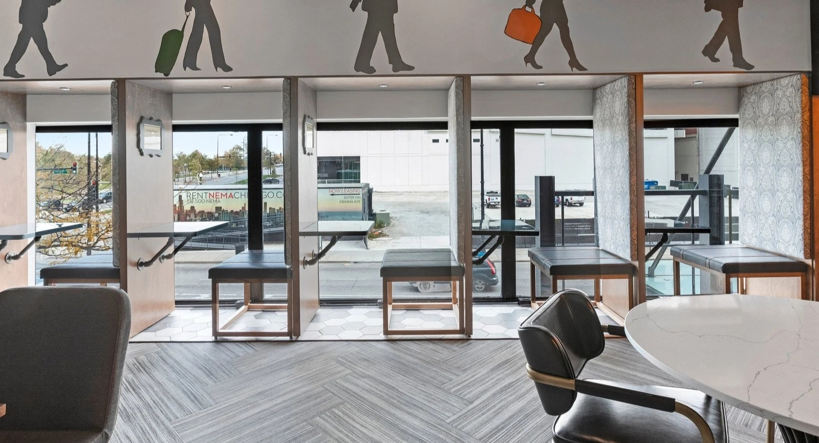 Innovative coworking space at Park Michigan in Chicago, featuring semi-private booths and a dynamic mural depicting urban life