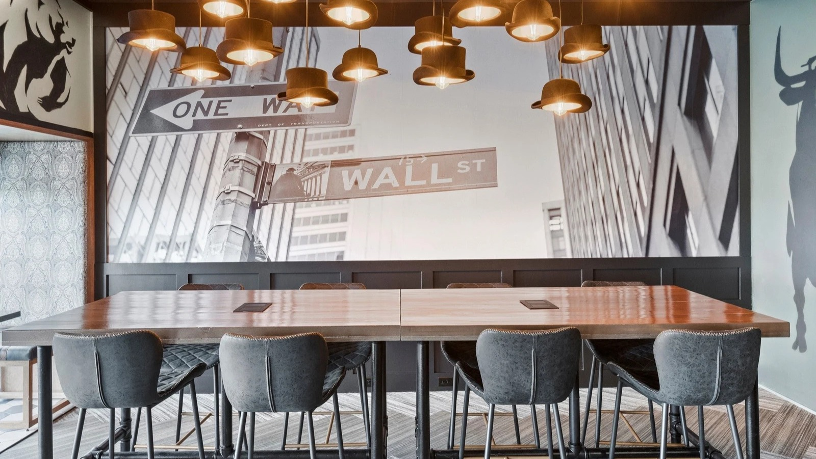 Unique coworking and dining space at Park Michigan in Chicago, featuring a large communal table and Wall Street-themed murals