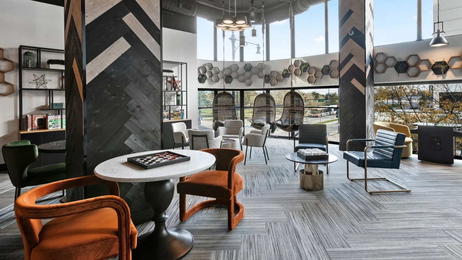 Vibrant lounge and game area at Park Michigan in Chicago, featuring eclectic seating arrangements and large windows with city views