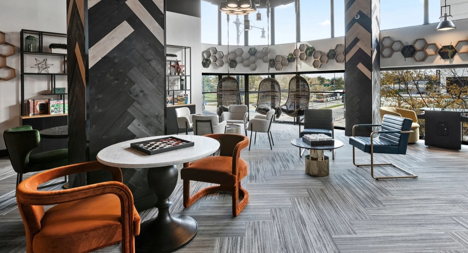 Vibrant lounge and game area at Park Michigan in Chicago, featuring eclectic seating arrangements and large windows with city views