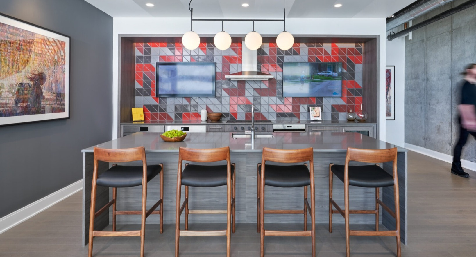 Vibrant resident lounge featuring a stylish bar area with tiled accents, TVs, and comfortable seating at Parkline Chicago in Chicago