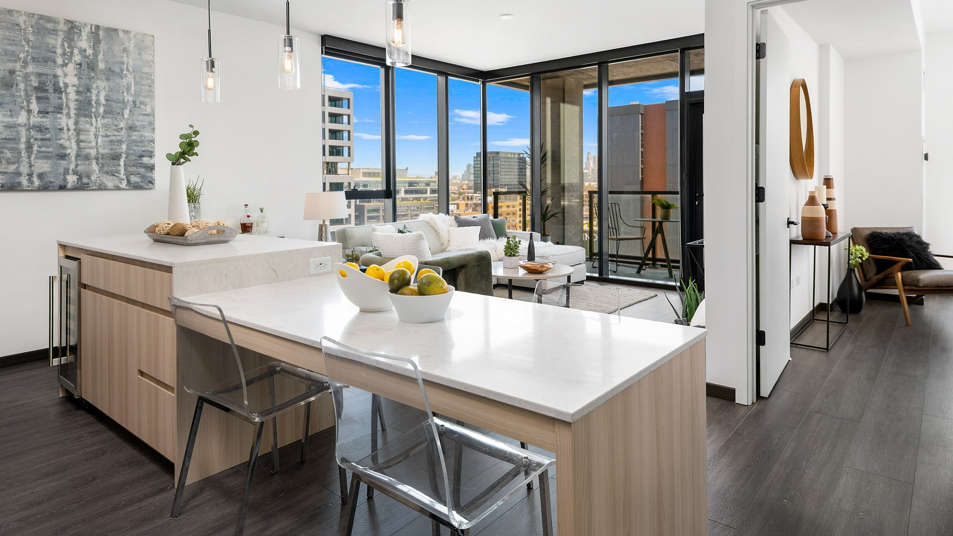 Open-concept apartment at Parq Fulton in Chicago, showcasing a seamless flow between the modern kitchen, dining, and living areas