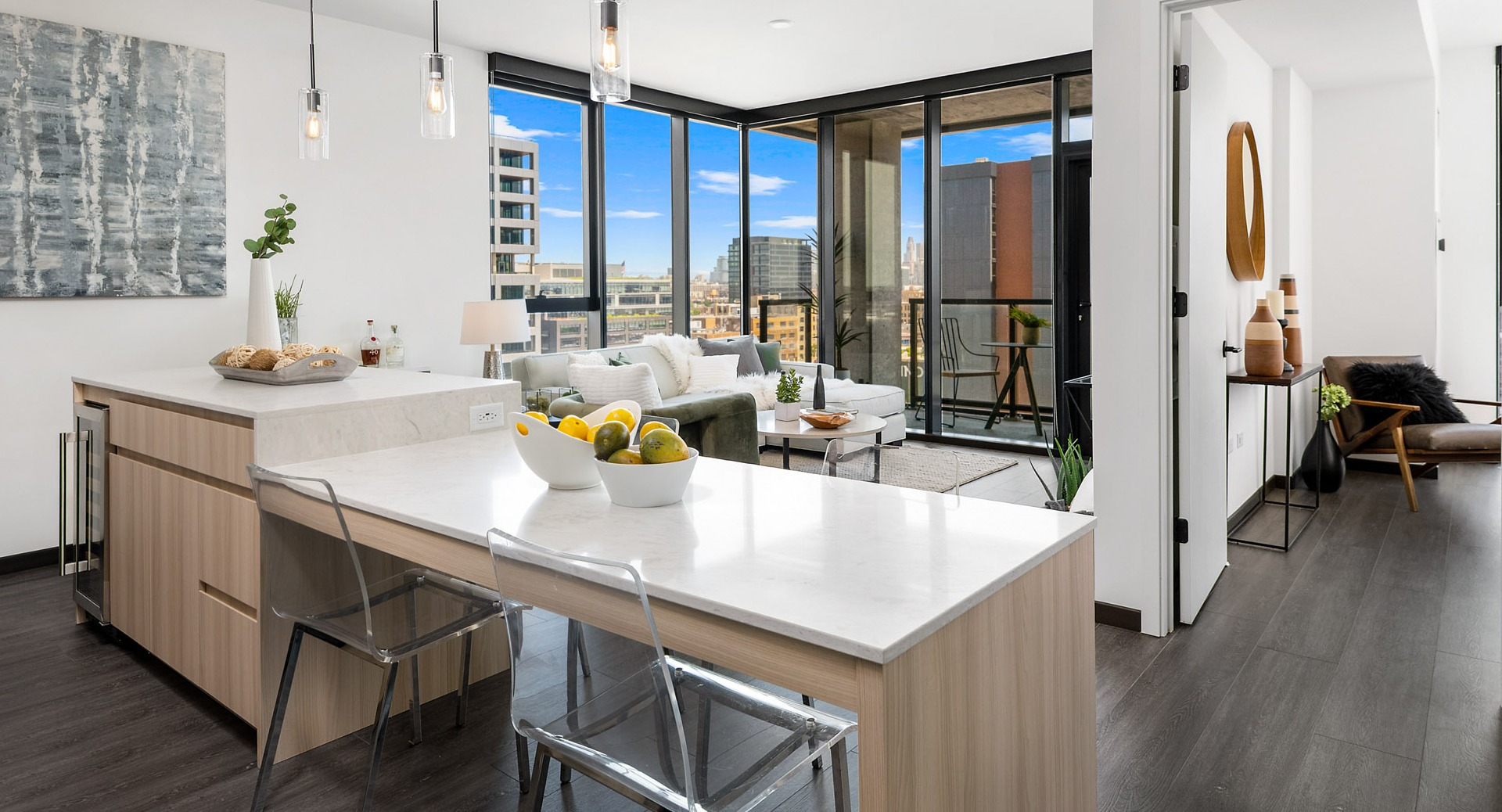 Open-concept apartment at Parq Fulton in Chicago, showcasing a seamless flow between the modern kitchen, dining, and living areas